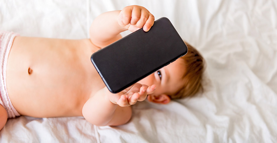 Baby holding up a phone