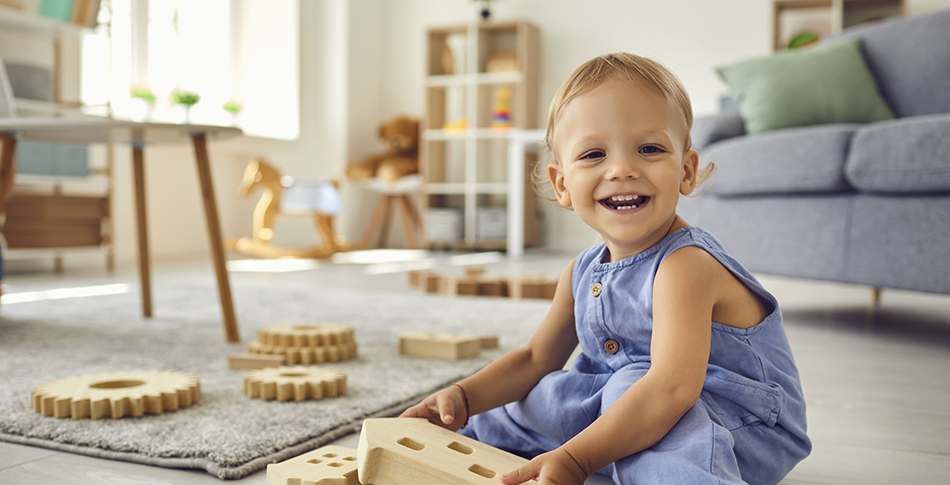 Happy girl playing with wooden toys